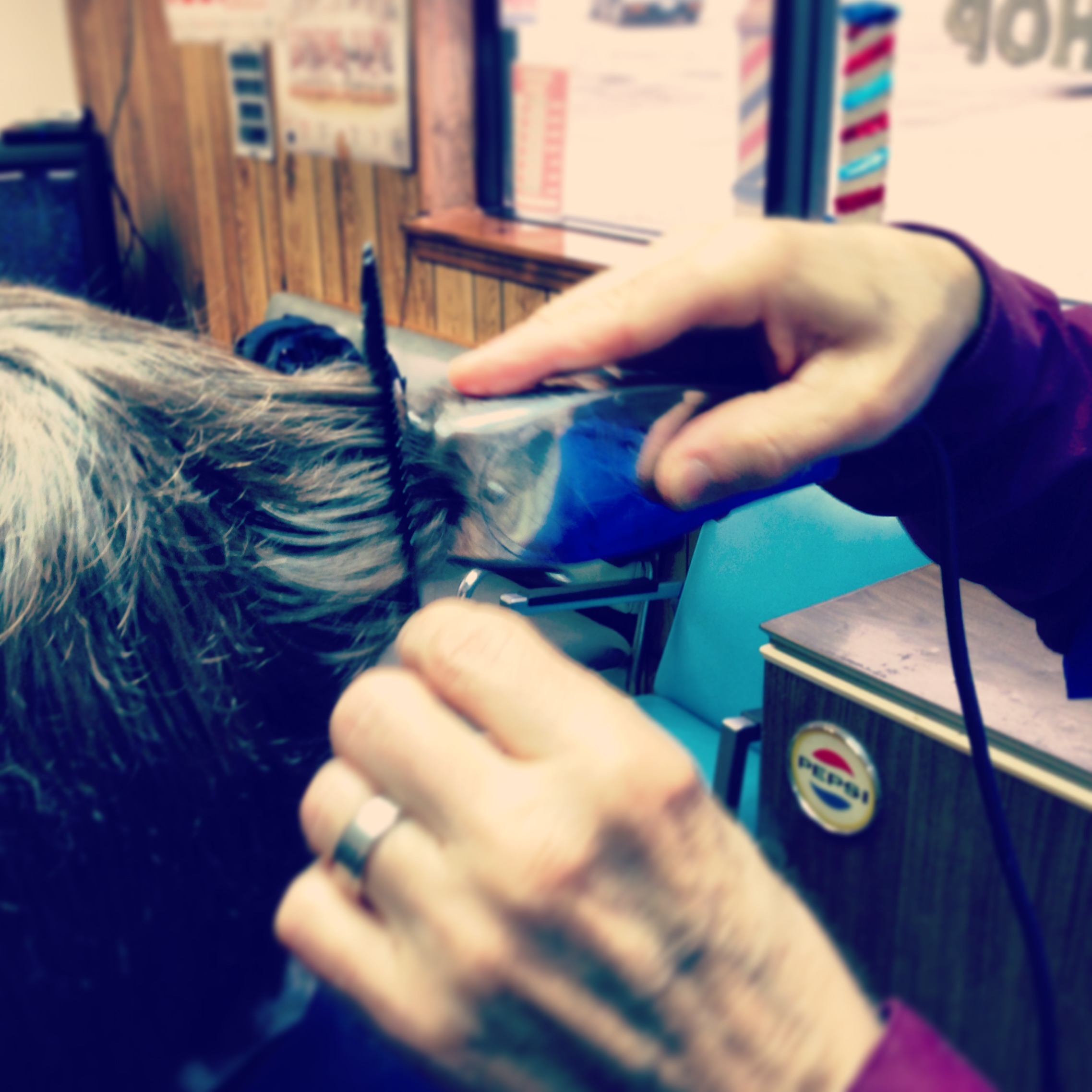 Gene cuts a customer's hair at his shop.